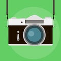 Retro camera in a flat style on a colored background. Old camera with strap. Vintage film camera. Vector illustration Royalty Free Stock Photo