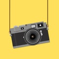 Retro camera in a flat style yellow background. Old camera with strap. Royalty Free Stock Photo