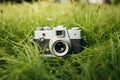 Retro camera in the green grass, close up view. AI generated Royalty Free Stock Photo