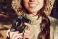 Retro camera in hand of young photographer girl and ready to take photo. Royalty Free Stock Photo