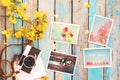 Retro camera and paper photo album on wood table with flowers border design