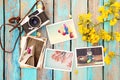 Retro camera and paper photo album on wood table with flowers border design