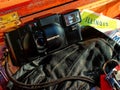 Retro camera rests on leather glove and maps in wood chest