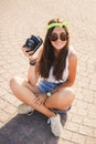 Retro camera shoots girl in the streets of the city. Royalty Free Stock Photo