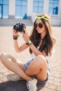 Retro camera shoots girl in the streets of the city. Royalty Free Stock Photo