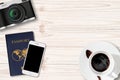 Retro camera,Smartphone and passport on wood Table