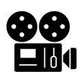 Retro camera solid icon. Film camera with strip vector illustration isolated on white. Old moovie camera glyph style