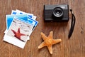 Retro camera, starfish and some photos on a wooden surface Royalty Free Stock Photo