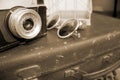 Retro camera, sunglasses and suitcase in sepia