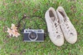 Retro camerar and sneakers on the grass