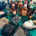 Retro cameras with leather case, photography equipment, whisky bottles on the showcase at sunday flea market