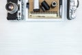 Retro cameras and negative films on white wooden background Royalty Free Stock Photo