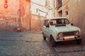 Retro car on ancient street of Girona, paving stone