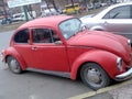 Retro car classic Fol`ksvagen Beetle Bitl VW Kafer red color in the street of city