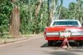 A retro car decorated for a wedding with the words just married and tin cans on ribbons. Wedding decorations outdoor Royalty Free Stock Photo