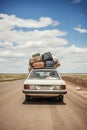 Retro car with luggage on the roof. Car on the road with a lot of suitcases on roof Royalty Free Stock Photo