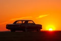 Retro car silhouette on sunset at summertime 1960s Royalty Free Stock Photo