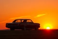 Retro car silhouette on sunset at summertime 1960s Royalty Free Stock Photo