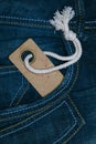 Retro cardboard paper tag with string in denim jeans pocket Royalty Free Stock Photo
