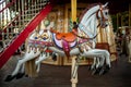 Retro carousel white, black horse. Old wooden horse carousel. Royalty Free Stock Photo