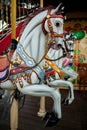 Retro carousel white, black horse. Old wooden horse carousel.