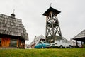 Retro cars parked near wooden tower