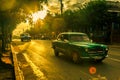 Retro cars on the streets of Vinales in sunset ray lights, Pinar Del Rio