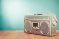 Retro cassette ghetto blaster on wooden table front mint blue background. Vintage style filtered photo