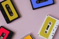 Retro cassette tape collection on pink background, top view. cop