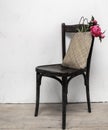 Retro chair in empty room with straw bag and flowers Royalty Free Stock Photo