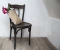 Retro chair in empty room with straw bag and flowers Royalty Free Stock Photo