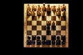 Retro chess board with figures from USSR on a black background. Chess opening Queen Gambit, top view Royalty Free Stock Photo