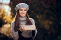 Retro Chic Girl with Beret Holding a Paper Wrapped Package Royalty Free Stock Photo