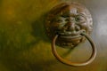 Retro chinese asian style decoration craft face of ring from mouth. material made from brass golden color. Old tradition craft bud