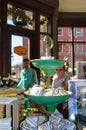 Retro Christmas Shopping - vintage stand of embroidered pillows of states - blurred shoppers and christmas decorations in backgrou