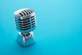 Retro chrome microphone on blue background with copy space. Business communication or entertainment concept