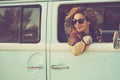 Retro classic travel vehicle and people concept. One Beautiful adult woman inside a blue van. Transport vehicle and freedom.