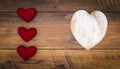 Retro classic Valentine`s Day cad, large white painted wooden hart, isolated, 3 red cuddle harts, on vintage oak panels - top view Royalty Free Stock Photo