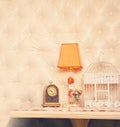 Retro clock, lamp and birdcage backdrop. Royalty Free Stock Photo