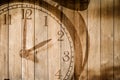 Retro clock on wood background selective focus at number 2 o`clock