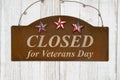 Retro closed for Veterans Day rusted sign on weathered wood Royalty Free Stock Photo