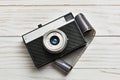 Retro compact photo camera and film on white Royalty Free Stock Photo