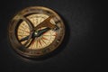 Retro compass on black board background. Close up. Royalty Free Stock Photo