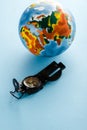 retro compass near colorful globe on