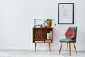 Retro composition of living room interior with mock up poster map, wooden shelf, book, armchair, plant, cacti, vinyl recorder.