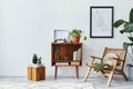 Retro composition of living room interior with mock up poster map, wooden shelf, book, armchair, plant, cacti, vinyl recorder.