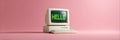 Retro computer displaying hello message on pink background Royalty Free Stock Photo