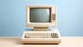 Retro computer with monitor and keyboard on a table against a blue background Royalty Free Stock Photo