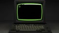 Vintage Computer Terminal with Green Screen and Keyboard on Dark Background Royalty Free Stock Photo