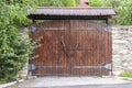 Retro countryside wooden gate with with stone wall in vintage style